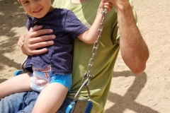 Daddy and Colton swinging at "Lake Park"